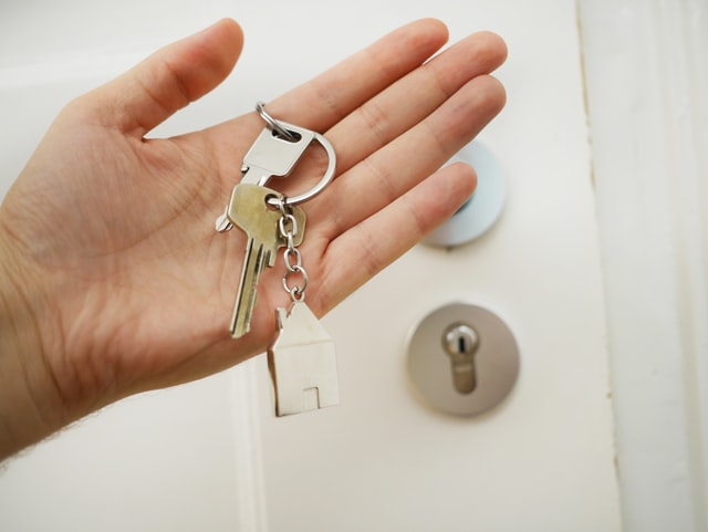 a%20person%20holding%20a%20house%20key